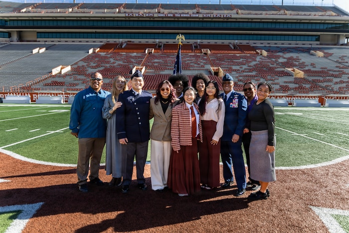 U.S. Space Force 2nd Lt. Kimo Martinez, Air Force ROTC Detachment 825, poses with his family and friends for a group photo after his winter commissioning ceremony at Darrell K Royal–Texas Memorial Stadium in Austin, Texas, Dec. 21, 2025.