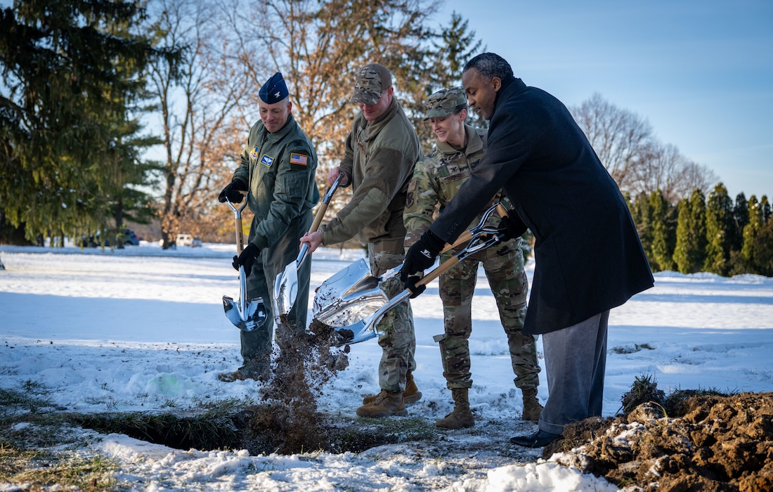Col. Dustin Richards, 88th Air Base Wing and Installation Commander, Col. Marietta Sanders,  88th Mission Support Group Commander, Col. Michael Frayser, 88th Medical Group Commander, and Amir Mott, 88th Civil Engineering director, took part in the 88th Air Base Wing Time Capsule Burial Ceremony Dec. 16, 2025, at Wright-Patterson Air Force Base, Ohio. The event marked the burial of a new time capsule, following the opening of the previous one from 1999 earlier this year. (U.S. Air Force photo by Jack Gardner.)