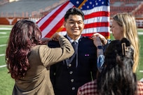 Cadet Kimo Martinez is pinned as a second lieutenant in the U.S. Space Force during Air Force ROTC Detachment 825’s winter 2025 commissioning ceremony at Darrell K Royal–Texas Memorial Stadium in Austin, Texas, on Dec. 21, 2025.
