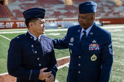 U.S. Space Force 2nd Lt. Kimo Martinez, Air Force ROTC Detachment 825, talks with retired Air Force Senior Master Sgt. James Henry during his winter commissioning ceremony at Darrell K Royal–Texas Memorial Stadium in Austin, Texas, Dec. 21, 2025.