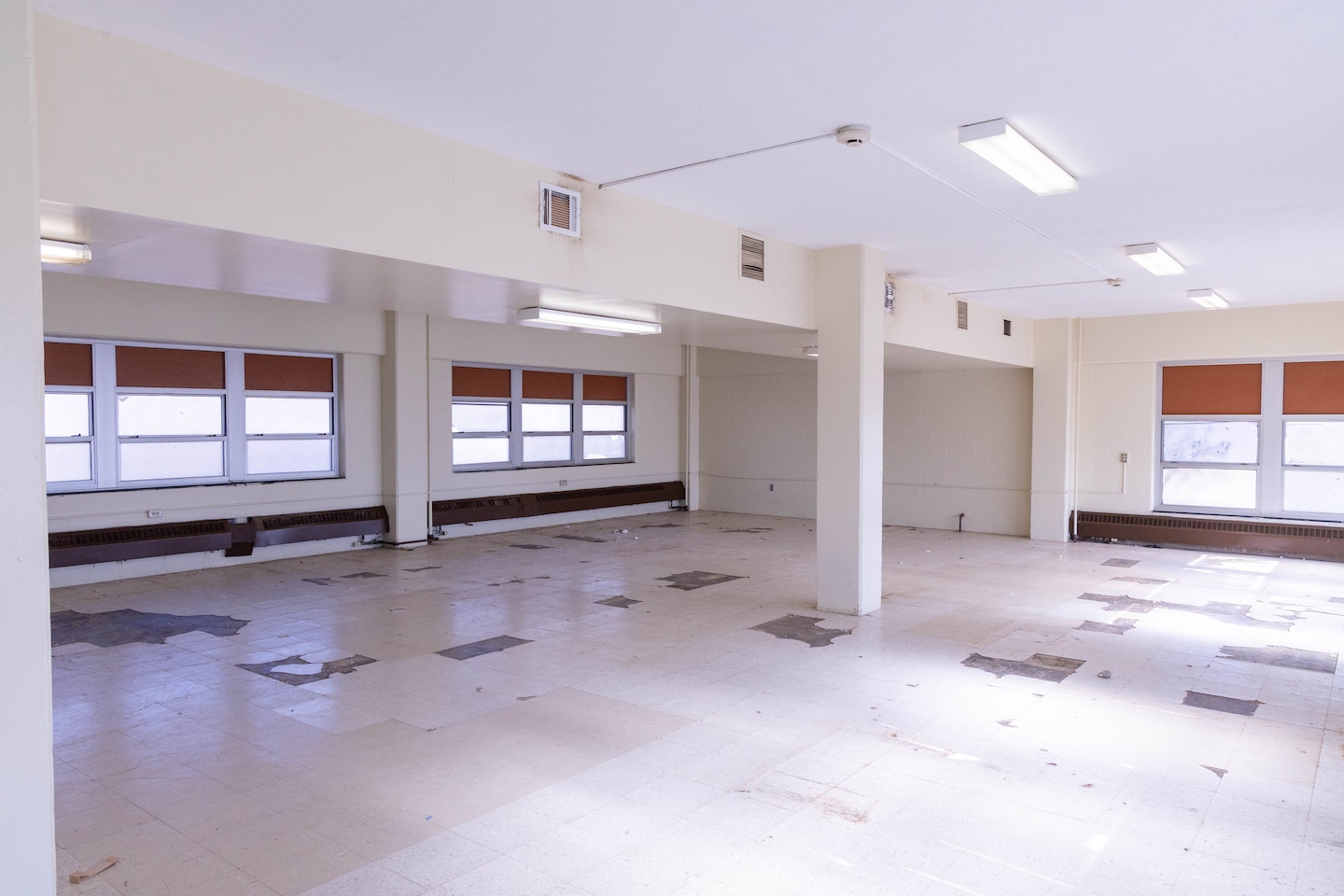A beige room with windows.