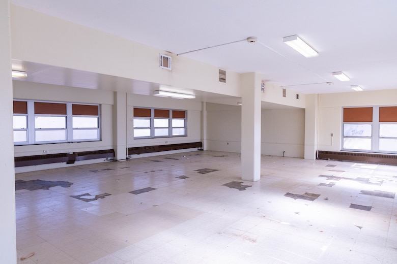 A beige room with windows.