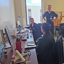 250904-N-ME175-1008 JACKSONVILLE, FL (Sept. 9, 2025) Cmdr. Daniel Kuckel, right, Naval Hospital Jacksonville Family Medicine Program director, listens to the discussion on how to treat a Northeast Florida University of Florida Health patient by Lt. Brinna Fiegl and Lt. Clarence Mai. This is a first-ever program for the residents to treat non-military patients, along with program faculty. (U.S. Navy photo by Julie M. Lucas)