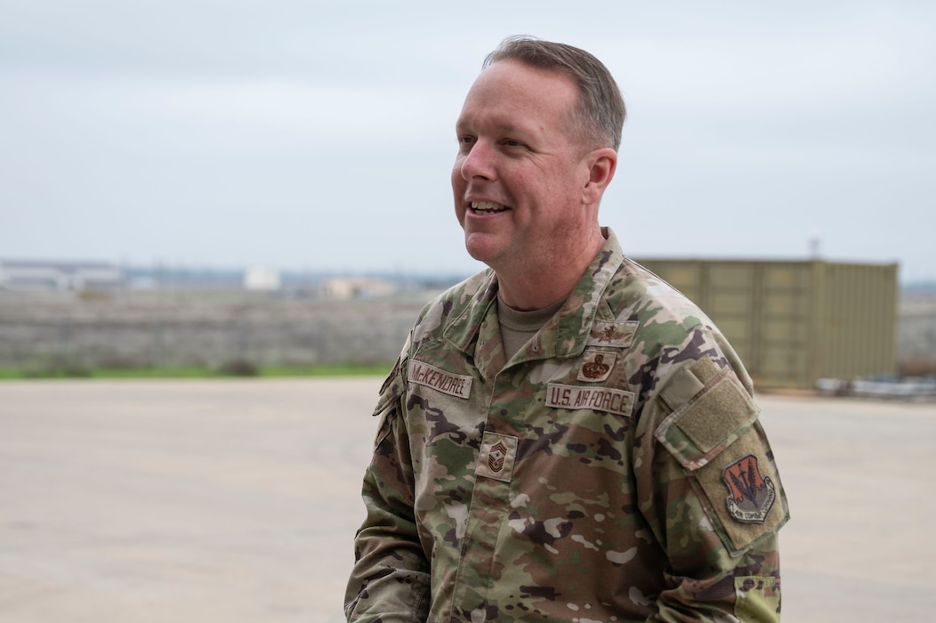 U.S. Air Force Chief Master Sgt. Andrew McKendree, Command Chief Master Sgt. of the 16th Air Force, smiles after a tour of the 9th Munitions storage area on Beale Air Force Base, California, Dec. 17, 2025.