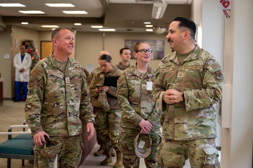 U.S. Air Force Chief Master Sgt. Andrew McKendree, Command Chief Master Sgt. of the 16th Air Force, is briefed by Master Sgt. Adam Whiteman, 9th Medical Group senior enlisted leader, during a tour of the clinic on Beale Air Force Base, California, Dec. 17, 2025.