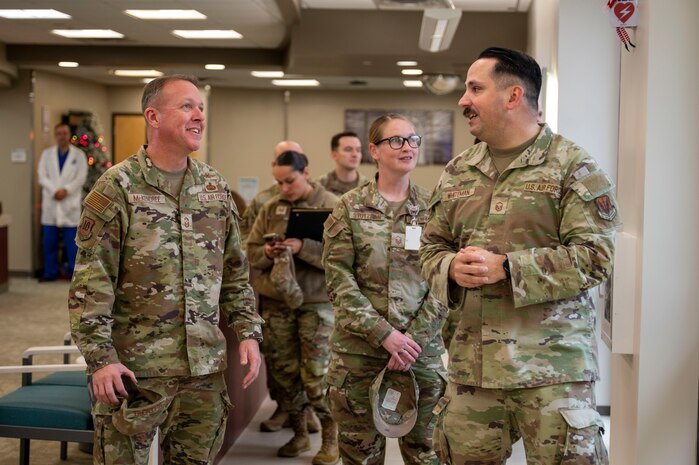 U.S. Air Force Chief Master Sgt. Andrew McKendree, Command Chief Master Sgt. of the 16th Air Force, is briefed by Master Sgt. Adam Whiteman, 9th Medical Group senior enlisted leader, during a tour of the clinic on Beale Air Force Base, California, Dec. 17, 2025.