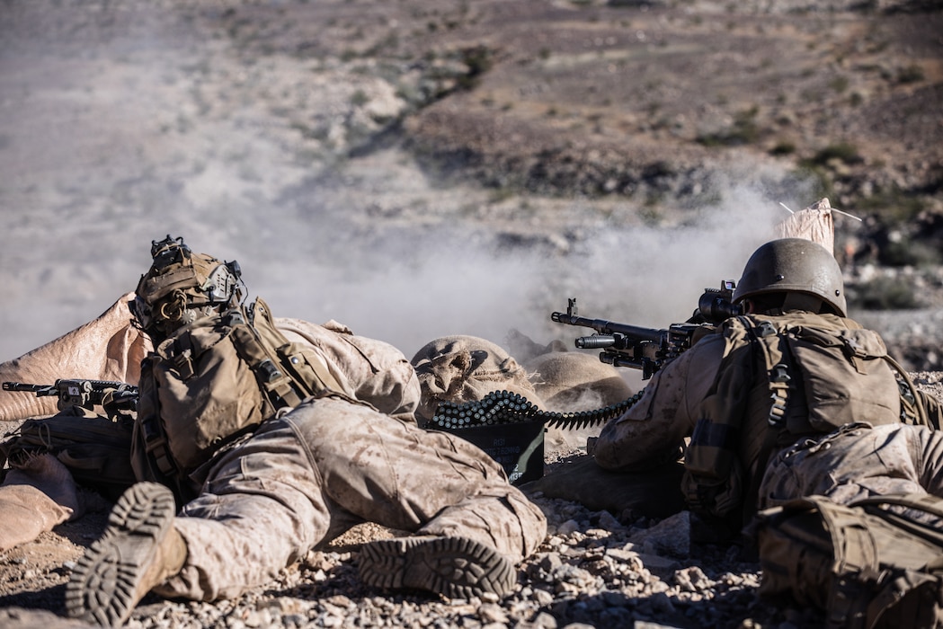 U.S. Marine Corps Lance Cpl. Elijah Gottler, left, Michigan native, and Pfc. Jackson Belsan, Boston native, both infantry Marines with 2nd Battalion, 4th Marine Regiment, 1st Marine Division, provide suppressive fire during a combined arms live fire training event at Range 400, Marine Corps Air Ground Combat Center, Twentynine Palms, California, Dec. 15, 2025. Range 400 is a dynamic live-fire range that allows companies the ability to rehearse tactics and procedures for attacking fortified areas. (U.S. Marine Corps photo by Lance Cpl. Cleo Wang)