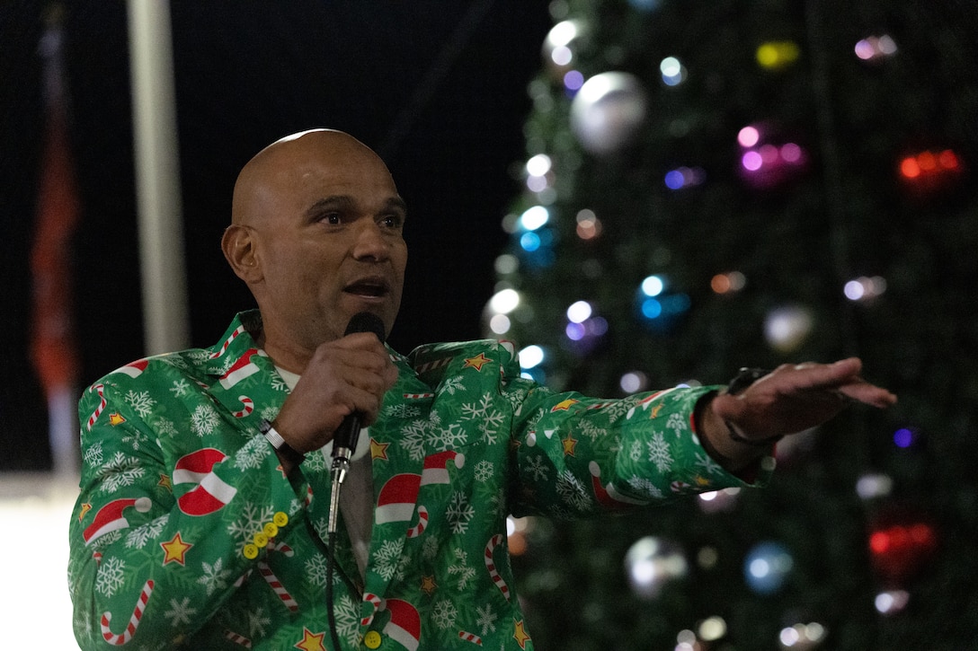 U.S. Marine Corps Sgt. Maj. Roberto Lopez, sergeant major of Marine Air Ground Task Force Training Command, Marine Corps Air Ground Combat Center, speaks to service members and their families during the annual Marine Corps Community Services Twentynine Palms Christmas Tree Lighting Ceremony at MCAGCC, Twentynine Palms, California, December 5, 2025. The tree lighting ceremony is an annual event to kick off the holiday season with music, food, and fun to enhance the quality of life for the service members and Department of War civilians of The Combat Center. (U.S. Marine Corps photo by Lance Cpl. Cody Fitzgerald)
