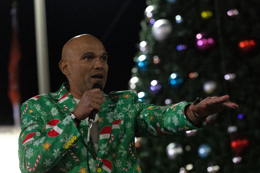 U.S. Marine Corps Sgt. Maj. Roberto Lopez, sergeant major of Marine Air Ground Task Force Training Command, Marine Corps Air Ground Combat Center, speaks to service members and their families during the annual Marine Corps Community Services Twentynine Palms Christmas Tree Lighting Ceremony at MCAGCC, Twentynine Palms, California, December 5, 2025. The tree lighting ceremony is an annual event to kick off the holiday season with music, food, and fun to enhance the quality of life for the service members and Department of War civilians of The Combat Center. (U.S. Marine Corps photo by Lance Cpl. Cody Fitzgerald)
