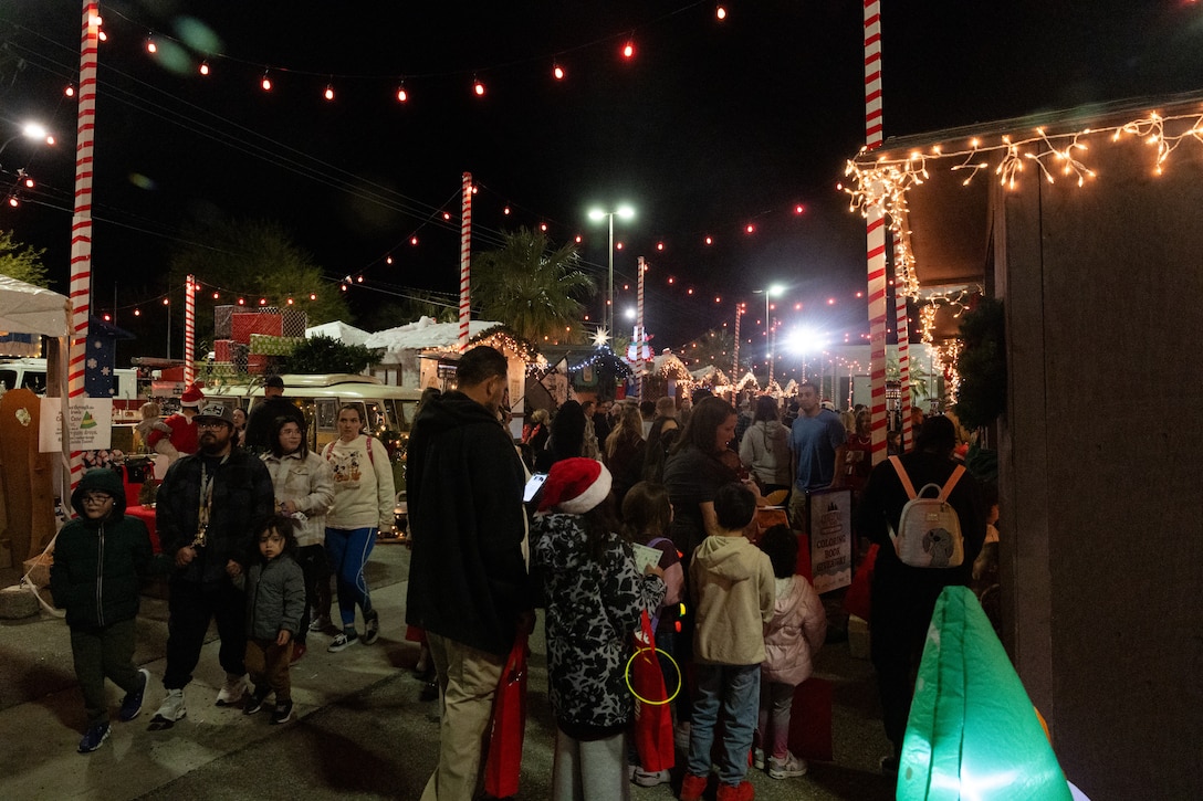 U.S. service members, civilians, and their families attend the annual Marine Corps Community Services Twentynine Palms Christmas Tree Lighting Ceremony at Marine Corps Air Ground Combat Center, Twentynine Palms, California, December 5, 2025. The tree lighting ceremony is an annual event to kick off the holiday season with music, food, and fun to enhance the quality of life for the service members and Department of War civilians of The Combat Center. (U.S. Marine Corps photo by Lance Cpl. Cody Fitzgerald)