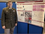 U.S. Army Capt Bradley Pierce, General Surgery Resident Physician at Tripler Army Medical Center, Honolulu, Hi. poses with his research Project on ECMO life support.