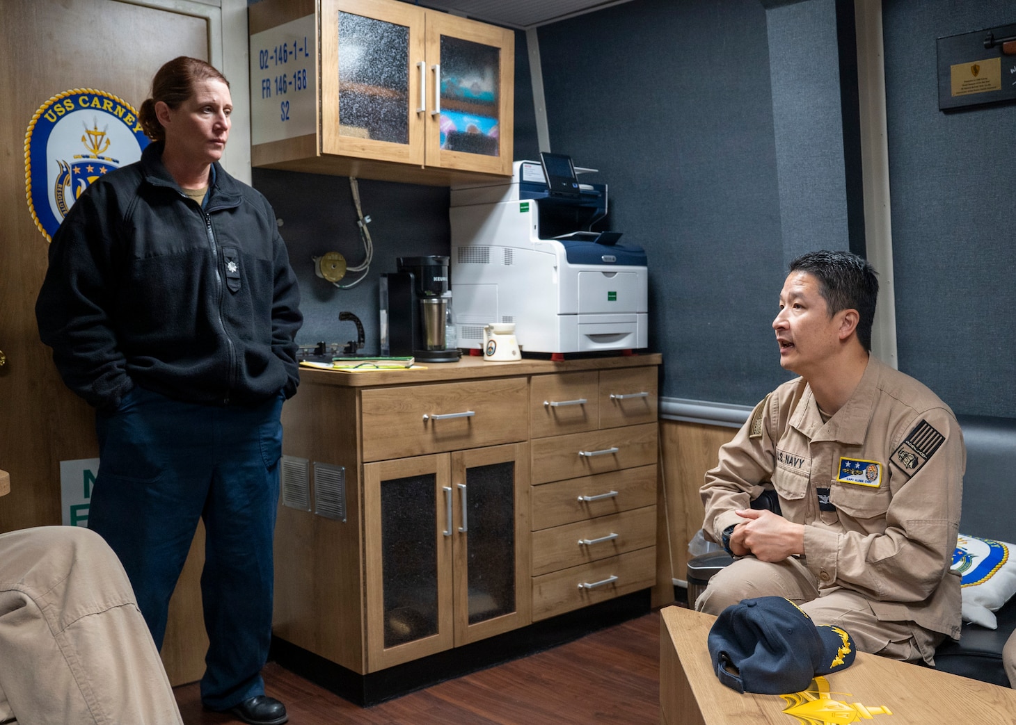 251208-N-IX644-1002 (Dec. 8, 2025) MAYPORT, Fla. U.S. Navy Capt. Alden Chiu, right, Force Surgeon, Naval Surface Force Atlantic, speaks with Cmdr. Meagan Makarenko, executive officer, USS Carney (DDG 64), during the pilot of the Joint Operational Medicine Information System (JOMIS) Operational Medicine Care Delivery Platform (OpMed CDP), in Mayport, Dec. 8. For 250 years, Navy Medicine — represented by more than 44,000 highly-trained military and civilian healthcare professionals — has delivered quality healthcare and enduring expeditionary medical support to the warfighter on, below, and above the sea, and ashore. (U.S. Navy photo by Mass Communication Specialist 2nd Class Sasha Ambrose)
