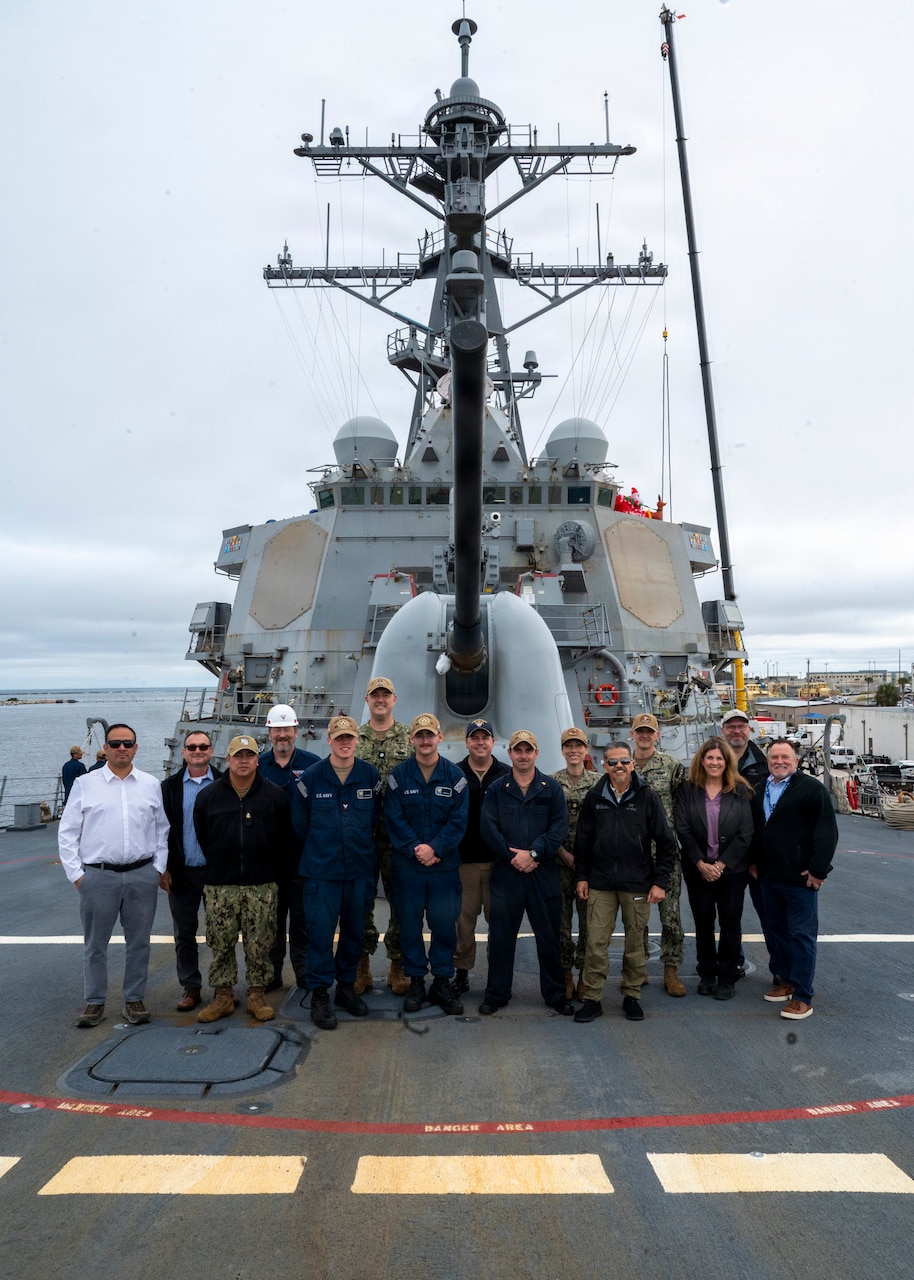 251208-N-IX644-1001 (Dec. 8, 2025) MAYPORT, Fla. U.S. Navy Sailors assigned to the USS Carney (DDG 64) and various Navy Medicine commands, alongside civilian and contractor partners, pose for a photo on the ship's flight deck during the pilot of the Joint Operational Medicine Information System (JOMIS) Operational Medicine Care Delivery Platform (OpMed CDP), a new modernized digital health record system, in Mayport, Fla., Dec. 8, 2025. For 250 years, Navy Medicine has delivered quality healthcare and enduring expeditionary medical support to the warfighter on, below, and above the sea, and ashore.  (U.S. Navy photo by Mass Communication Specialist 2nd Class Sasha Ambrose)