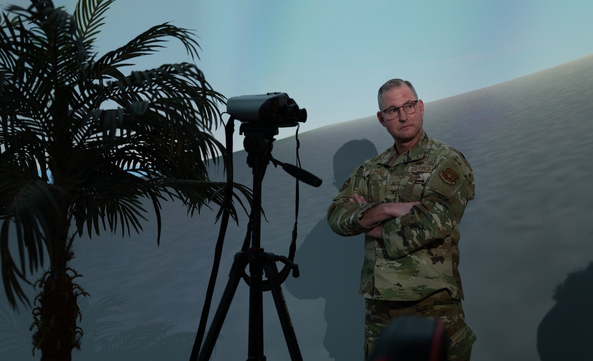 uniformed military member stands in dome simulator