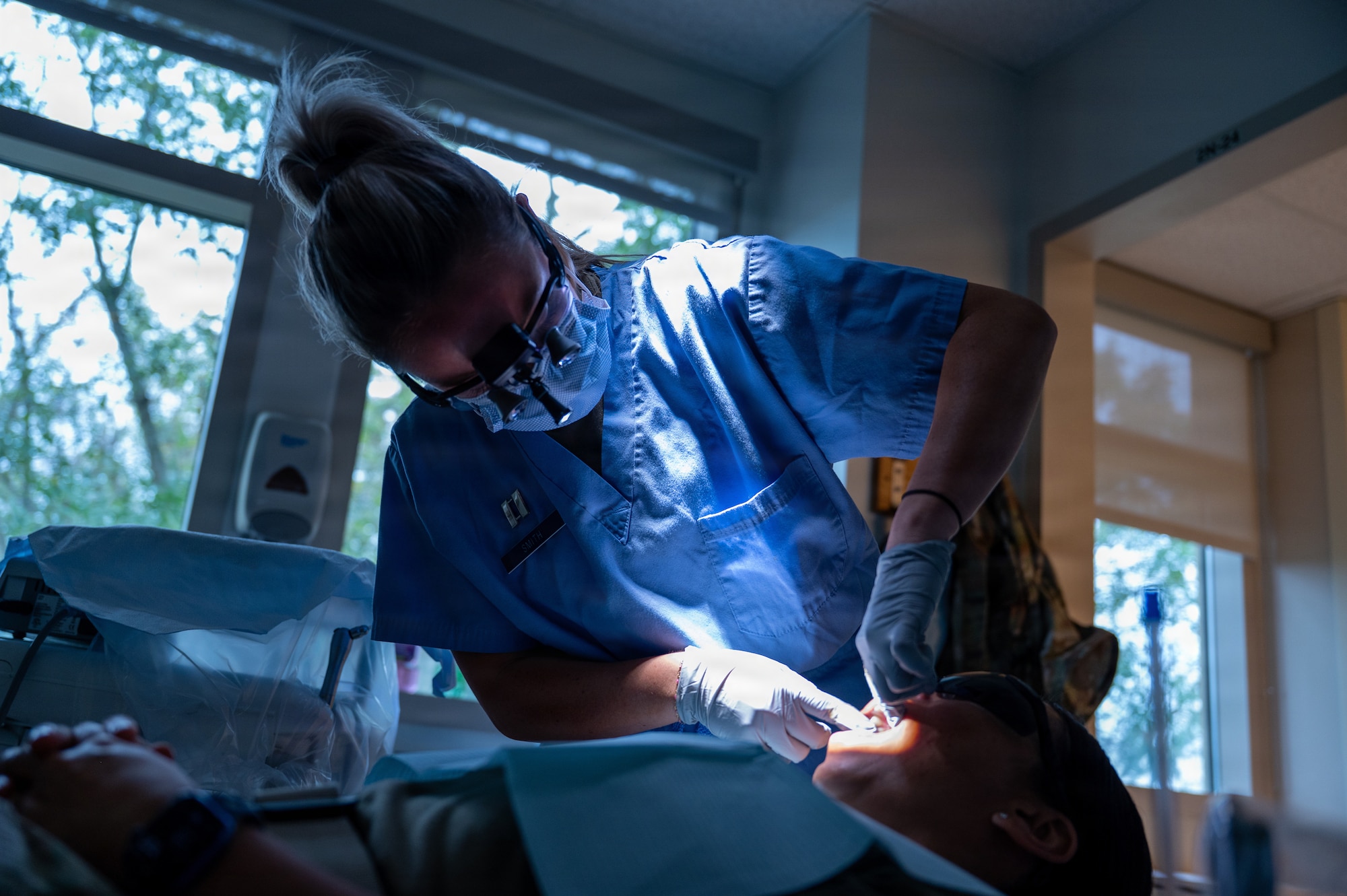 U.S. Air Force Capt. Taylor Smith, general dentist, Maxwell Medical Group, performs an oral examination on a patient at Maxwell Air Force Base, Alabama, Oct. 9, 2025. Air Force members are required to have yearly dental checks to maintain their readiness to deploy. (U.S. Air Force photo by Senior Airman Evan Porter)