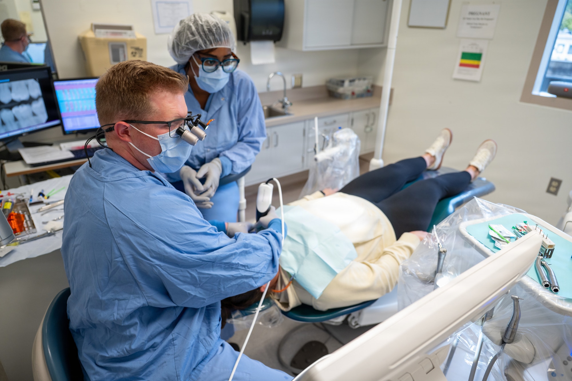 U.S. Air Force Capt. Thomas Hardison, comprehensive dentist, Maxwell Medical Group, and Nicole Ferguson, dental assistant, use a device to scan a patient’s teeth at Maxwell Air Force Base, Alabama, Oct. 9, 2025. The device gives dentists the ability to use technology to 3D print and mill various dental restorations. (U.S. Air Force photo by Senior Airman Evan Porter)