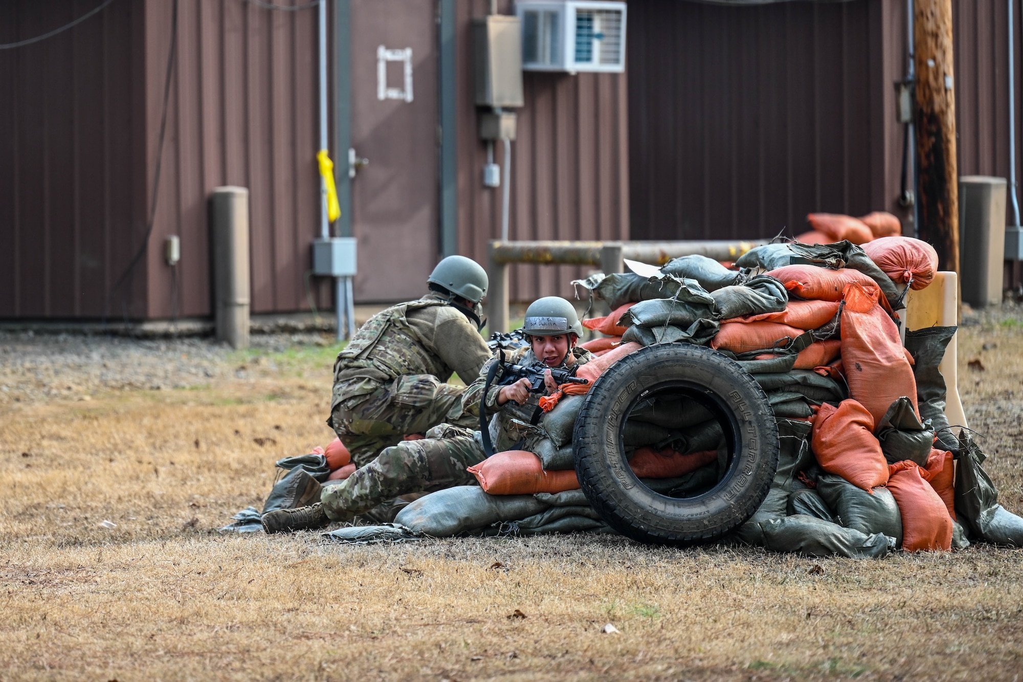 Airmen practice guarding a defensive fighting position during a training exercise.