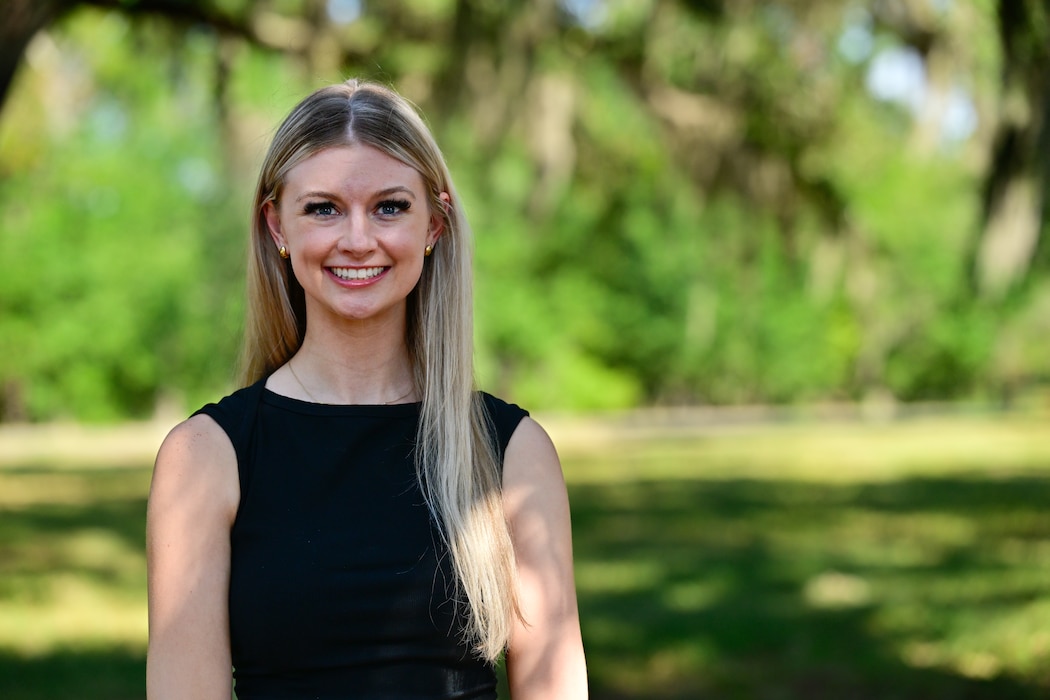 Allison Bayro, an intern with the Naval Research Lab poses for a photo, Aug. 16. Bayro, a biomedical engineering PhD candidate from Arizona State, has a background in physiological sensing and virtual reality and is part of the team in the Naval Aerospace Medical Institute's (NAMI) behavioral research lab. Her work centers around the implementation of Assessing Spatial Abilities in Naval Aviation (ASANA). Users of the system must navigate immersive scenarios with ever increasing levels of difficulty and are asked to answer questions designed to test a person's ability to multitask and think abstractly. ASANA uses eye tracking, motion, bio metric, reaction time, and behavioral monitoring to collect data in order to pair with a user's aptitude testing data to help determine their viability as a pilot or flight officer candidate. With five detachments, 12 training centers, and facilities in over 60 locations across the United States, NMOTC provides high impact individual medical training for the Navy, other U.S. armed forces, and allied nations around the globe. (U.S. Navy photo by Mass Communication Specialist 1st Class Russell Lindsey SW/AW)