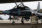 U.S. Air Force 2nd Lt. Raphael Relyea, 12th Training Squadron student, watches a T-38C Talon as a 435th Fighter Training Squadron pilot performs preflight checks prior to takeoff at Joint Base San Antonio-Randolph, Texas, Dec. 1, 2025. Students awaiting flight training participate in the Casual Lieutenant Program, assisting agencies across the installation with daily operations under close supervision while preparing for future leadership roles working with various mission partners. (U.S. Air Force photo by Kathryn R.C. Reaves)