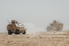 U.S. Soldiers assigned to Delta Company, 1st Battalion, 133rd Infantry Regiment, 2nd Brigade Combat Team, 34th Infantry Division, Iowa National Guard, operate Mine-Resistant Ambush Protected (MRAP) vehicles within the U.S. Central Command area of responsibility, Sept. 21, 2025. The unit, operating in support of Combined Joint Task Force – Operation Inherent Resolve, secured a landing zone to ensure the safe arrival of incoming personnel and visitors. (U.S. Army photo by Sgt. Zachary Ta)