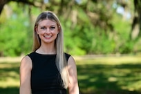 Allison Bayro, an intern with the Naval Research Lab poses for a photo, Aug. 16. Bayro, a biomedical engineering PhD candidate from Arizona State, has a background in physiological sensing and virtual reality and is part of the team in the Naval Aerospace Medical Institute's (NAMI) behavioral research lab. Her work centers around the implementation of Assessing Spatial Abilities in Naval Aviation (ASANA). Users of the system must navigate immersive scenarios with ever increasing levels of difficulty and are asked to answer questions designed to test a person's ability to multitask and think abstractly. ASANA uses eye tracking, motion, bio metric, reaction time, and behavioral monitoring to collect data in order to pair with a user's aptitude testing data to help determine their viability as a pilot or flight officer candidate. With five detachments, 12 training centers, and facilities in over 60 locations across the United States, NMOTC provides high impact individual medical training for the Navy, other U.S. armed forces, and allied nations around the globe. (U.S. Navy photo by Mass Communication Specialist 1st Class Russell Lindsey SW/AW)