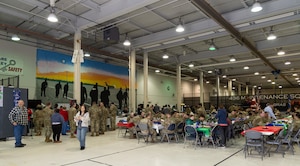 Volunteers serve meals to active duty, Reserve and civilians, and their family members during the 23rd annual Operation Feed The Troops at Dover Air Force Base, Delaware, Dec. 17, 2025. OFTT volunteers served a traditional holiday meal to members of Team Dover during lunch and dinner meal times. A total of 1,100 pounds of turkey was cooked and served to Team Dover members. (U.S. Air Force photo by Roland Balik)