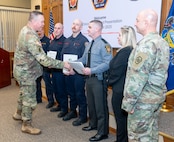 Fort Indiantown Gap firefighters: Assistant Chief Travis Duncan, Firefighter/EMT Jesse Berdanier, Firefighter/EMT Benjamin Condran; and Pennsylvania State Police Trooper Brody Myers receive the Clinical Save Award during a ceremony in the Hartranft Conference Room on Fort Indiantown Gap. The ceremony honors their life-saving efforts to resuscitate an individual involved in a vehicle accident on Interstate 81, near the installation, Dec. 5. (Pennsylvania National Guard photo by Wayne V. Hall)