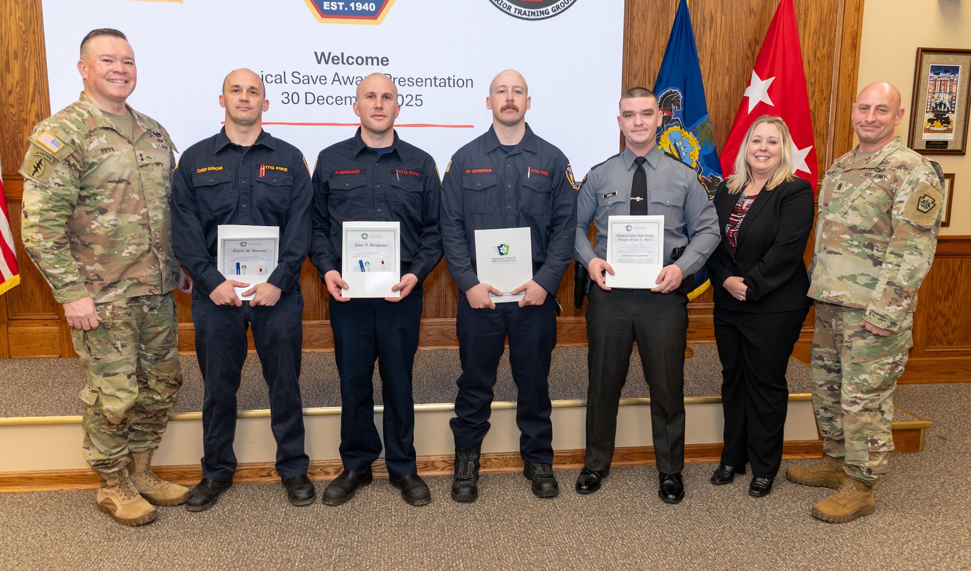 Fort Indiantown Gap firefighters: Assistant Chief Travis Duncan, Firefighter/EMT Jesse Berdanier, Firefighter/EMT Benjamin Condran; and Pennsylvania State Police Trooper Brody Myers receive the Clinical Save Award during a ceremony in the Hartranft Conference Room on Fort Indiantown Gap. The ceremony honors their life-saving efforts to resuscitate an individual involved in a vehicle accident on Interstate 81, near the installation, Dec. 5. (Pennsylvania National Guard photo by Wayne V. Hall)