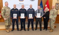 Fort Indiantown Gap firefighters: Assistant Chief Travis Duncan, Firefighter/EMT Jesse Berdanier, Firefighter/EMT Benjamin Condran; and Pennsylvania State Police Trooper Brody Myers receive the Clinical Save Award during a ceremony in the Hartranft Conference Room on Fort Indiantown Gap. The ceremony honors their life-saving efforts to resuscitate an individual involved in a vehicle accident on Interstate 81, near the installation, Dec. 5. (Pennsylvania National Guard photo by Wayne V. Hall)