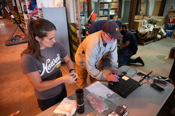 U.S. Army Corps of Engineers Sacramento District team members Ashley Lopez (left) environmental manager and David Colby (right) fisheries biologist, perform maintenance and a software update on the system used for the Juvenile Salmon Acoustic Telemetry System (JSATS) receivers that will be used for a telemetry survey on Sept. 10, 2025, in Stockton, California. The U.S. Army Corps of Engineers Sacramento District conducts telemetry surveys to close critical data gaps on green sturgeon passage in the lower Sacramento River, providing valuable information to partner agencies for setting river flow requirements, managing dam releases, and improving the survival of this federally protected species. (U.S. Army photo by Bertha Smith, U.S. Army Corps of Engineers Sacramento District Public Affairs)