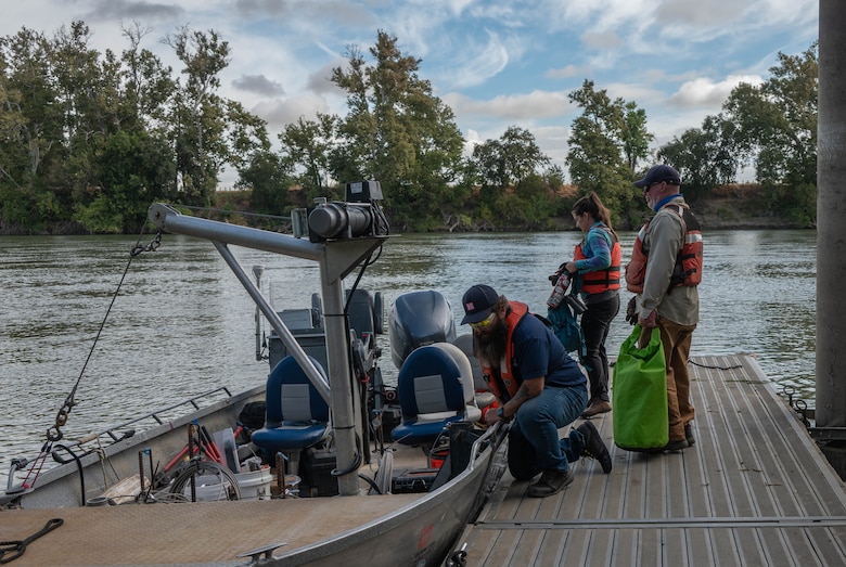 U.S. Army Corps of Engineers Sacramento District team members Greg Jerman, maintenance technician, Ashley Lopez, environmental manager, and David Colby, fisheries biologist, don safety gear before boarding a district boat in preparation for a telemetry survey on Sept. 10, 2025, in Stockton, California. U.S. Army Corps of Engineers Sacramento District environmental managers and Bryte Yard craftsmen collaborate and conduct telemetry surveys to close critical data gaps on green sturgeon passage in the lower Sacramento River, providing valuable information to partner agencies for setting river flow requirements, managing dam releases, and improving the survival of this federally protected species. (U.S. Army photo by Bertha Smith, U.S. Army Corps of Engineers Sacramento District Public Affairs)