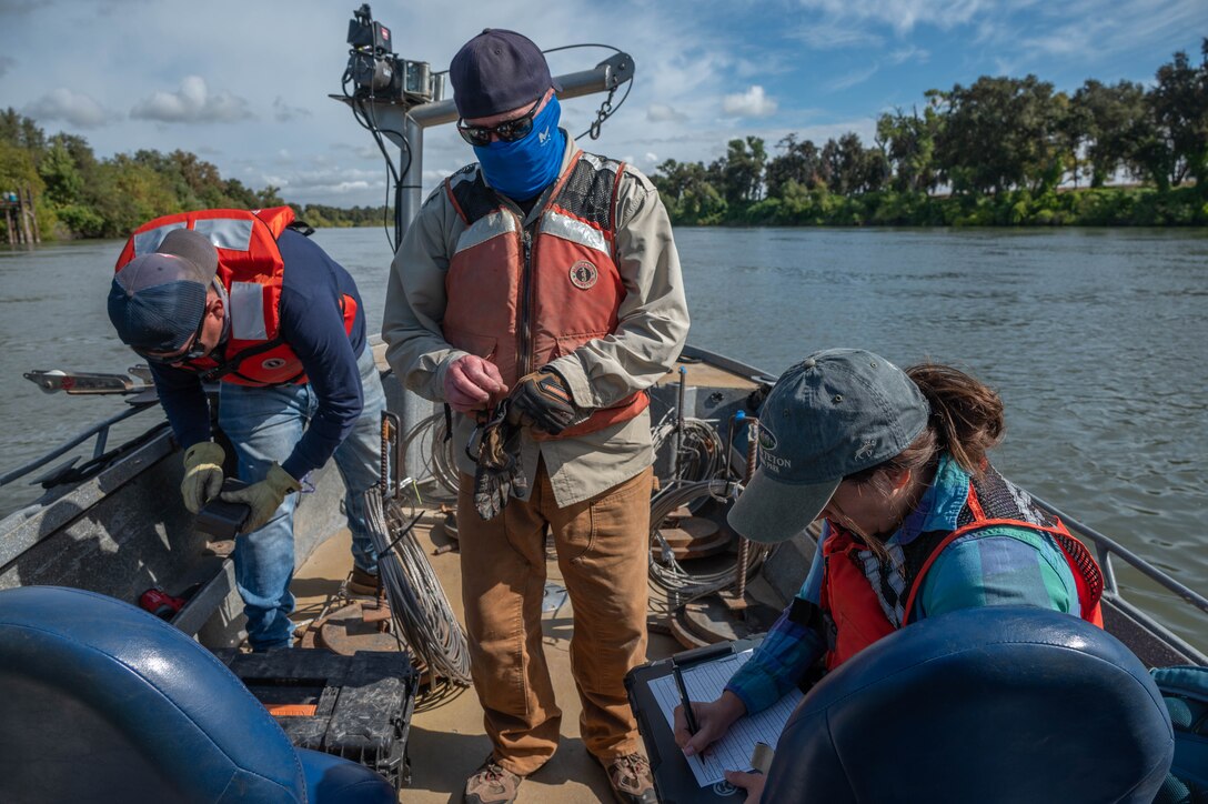 U.S. Army Corps of Engineers Sacramento District team members Aaron Siemsen, maintenance technician, David Colby, fisheries biologist, and Ashley Lopez, environmental manager, prepare their individual gear to begin a telemetry survey on Sept. 10, 2025, in Stockton, California. U.S. Army Corps of Engineers Sacramento District environmental managers and Bryte Yard craftsmen collaborate and conduct telemetry surveys to close critical data gaps on green sturgeon passage in the lower Sacramento River, providing valuable information to partner agencies for setting river flow requirements, managing dam releases, and improving the survival of this federally protected species. (U.S. Army photo by Bertha Smith, U.S. Army Corps of Engineers Sacramento District Public Affairs)