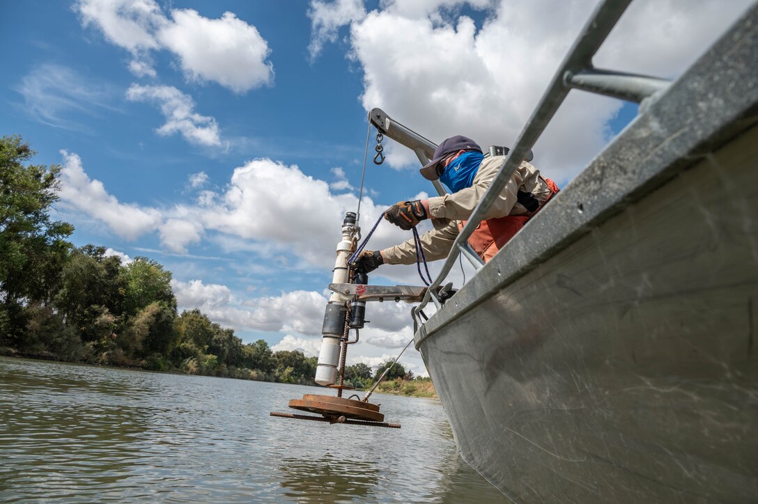 U.S. Army Corps of Engineers Sacramento District team member David Colby, environmental manager, lowers a Juvenile Salmon Acoustic Telemetry System (JSATS) receiver into the lower Sacramento River to conduct a telemetry survey that collects data on tagged green sturgeon on Sept. 10, 2025, in Stockton, California. U.S. Army Corps of Engineers Sacramento District environmental managers and Bryte Yard craftsmen collaborate and conduct telemetry surveys to close critical data gaps on green sturgeon passage in the lower Sacramento River, providing valuable information to partner agencies for setting river flow requirements, managing dam releases, and improving the survival of this federally protected species. (U.S. Army photo by Bertha Smith, U.S. Army Corps of Engineers Sacramento District Public Affairs)