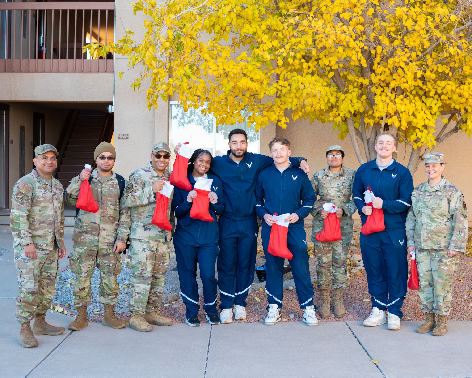First sergeants and dorm resident Airmen pose for a photograph during the Holloman Airmen Cookie Drive at Holloman Air Force Base, New Mexico, Dec. 9, 2025.