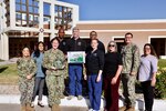 Staff members from Naval Hospital Twentynine Palms gather for a group photo Dec. 17 in recognition of the hospital earning an “A” safety grade from the Leapfrog Group. The designation reflects the collective efforts of physicians, nurses, pharmacists, technicians and support personnel whose daily commitment to patient safety, quality care and teamwork contributed to the hospital’s Leapfrog Top Hospital recognition. (U.S. Navy photo by Christopher Jones/NMRTC Twentynine Palms Public Affairs Officer)