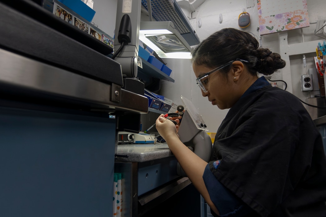 251223-N-PT073-1093 U.S. Navy Hospital Corpsman 3rd Class Angie Arens sands down a dental mold aboard Nimitz-class aircraft carrier USS Abraham Lincoln (CVN 72) on Dec. 23, 2025. The Abraham Lincoln Carrier Strike Group is underway conducting routine operations in the U.S. 7th Fleet area of operations. Units assigned to 7th Fleet conduct regular Indo-Pacific patrols to deter aggression, strengthen alliances and partnerships, and advance peace through strength. (U.S. Navy photo by Mass Communication Specialist Seaman Malina Davy)