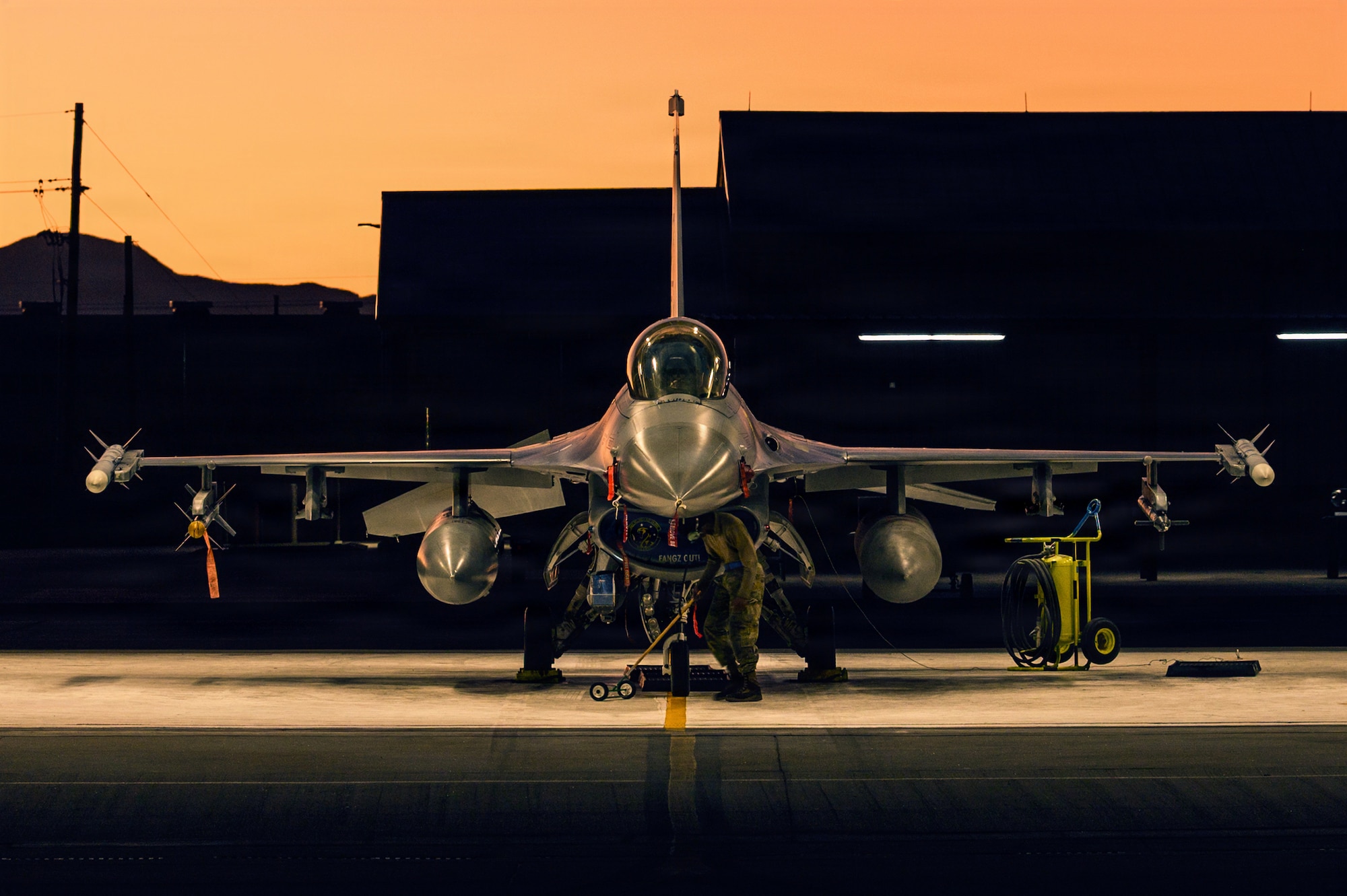 U.S. Air Force Airman 1st Class Noah Chastine, 311th Aircraft Maintenance Unit crew chief, performs scheduled maintenance on an F-16 Fighting Falcon at Holloman Air Force Base, New Mexico, Dec. 11, 2025.