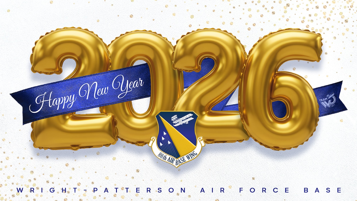 Golden foil ballons write "2026" with a blue "Happy New Year" banner. In front, is the 88th Air Base Wing's patch.