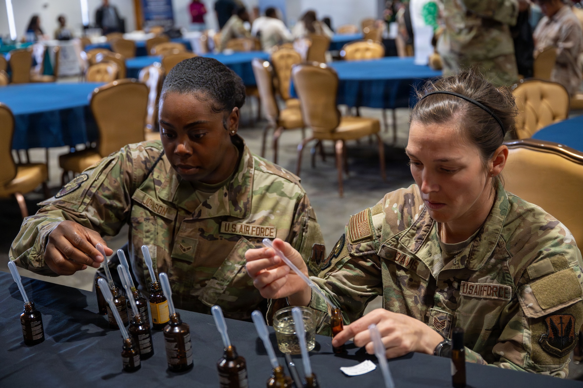 U.S. Airmen make their own aromatherapy oils during the “Connect 4 Wellness” fair at Davis-Monthan Air Force Base, Arizona, Dec. 23, 2025. The Community Action Team and UNITE program hosted the fair, bringing Airmen together with free food, games, and wellness activities to celebrate the holidays. (U.S. Air Force photo by Senior Airman Jasmyne Bridgers-Matos)