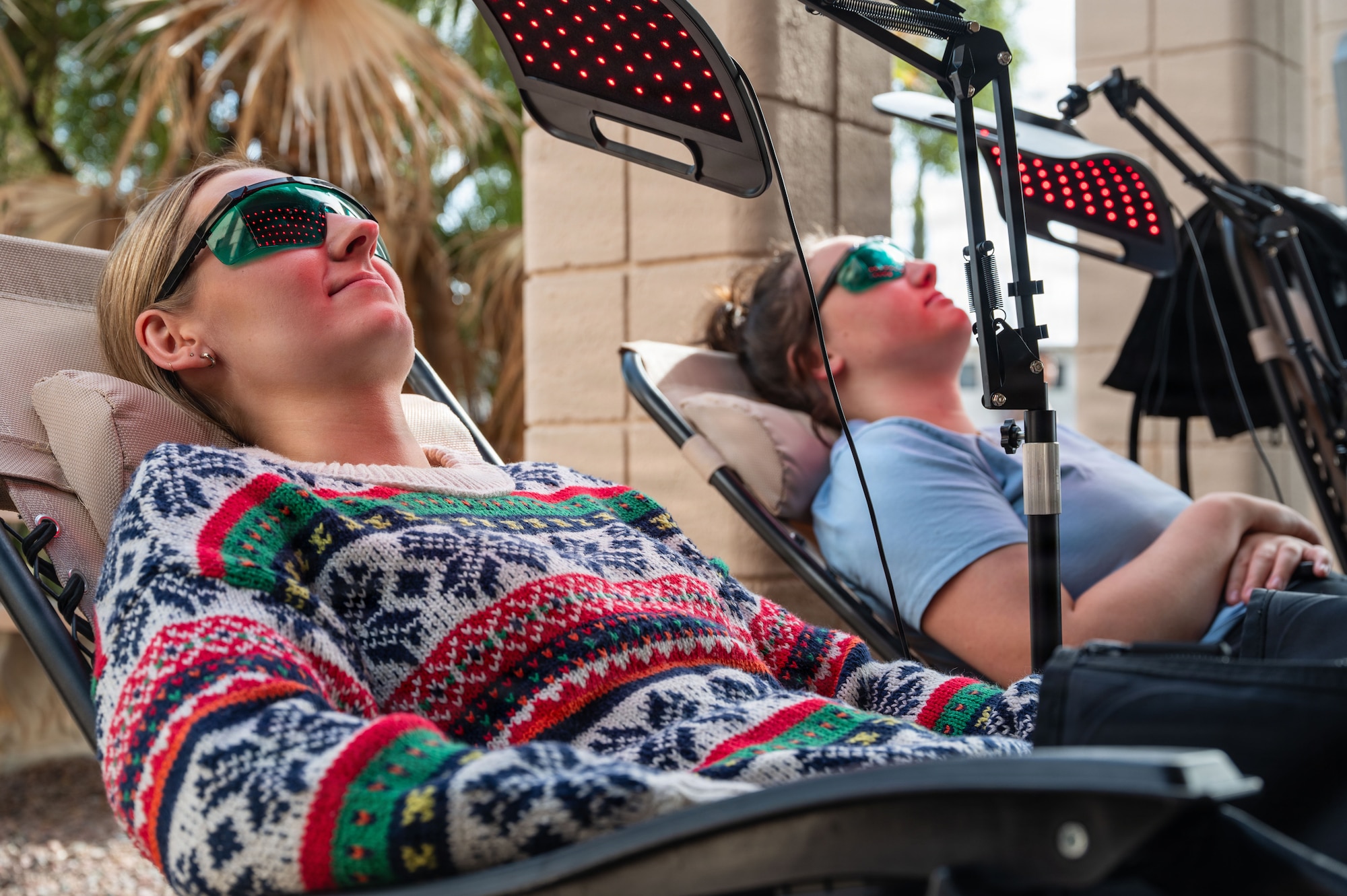 Members of the 355th Force Support Squadron marketing team unwind with compression boots at Davis-Monthan Air Force Base, Arizona, Dec. 23, 2025. The Community Action Team and UNITE program hosted a “Connect 4 Wellness” fair, bringing the Desert Lightning team together for free food, games, and wellness activities to celebrate the holidays. (U.S. Air Force photo by Senior Airman Jasmyne Bridgers-Matos)