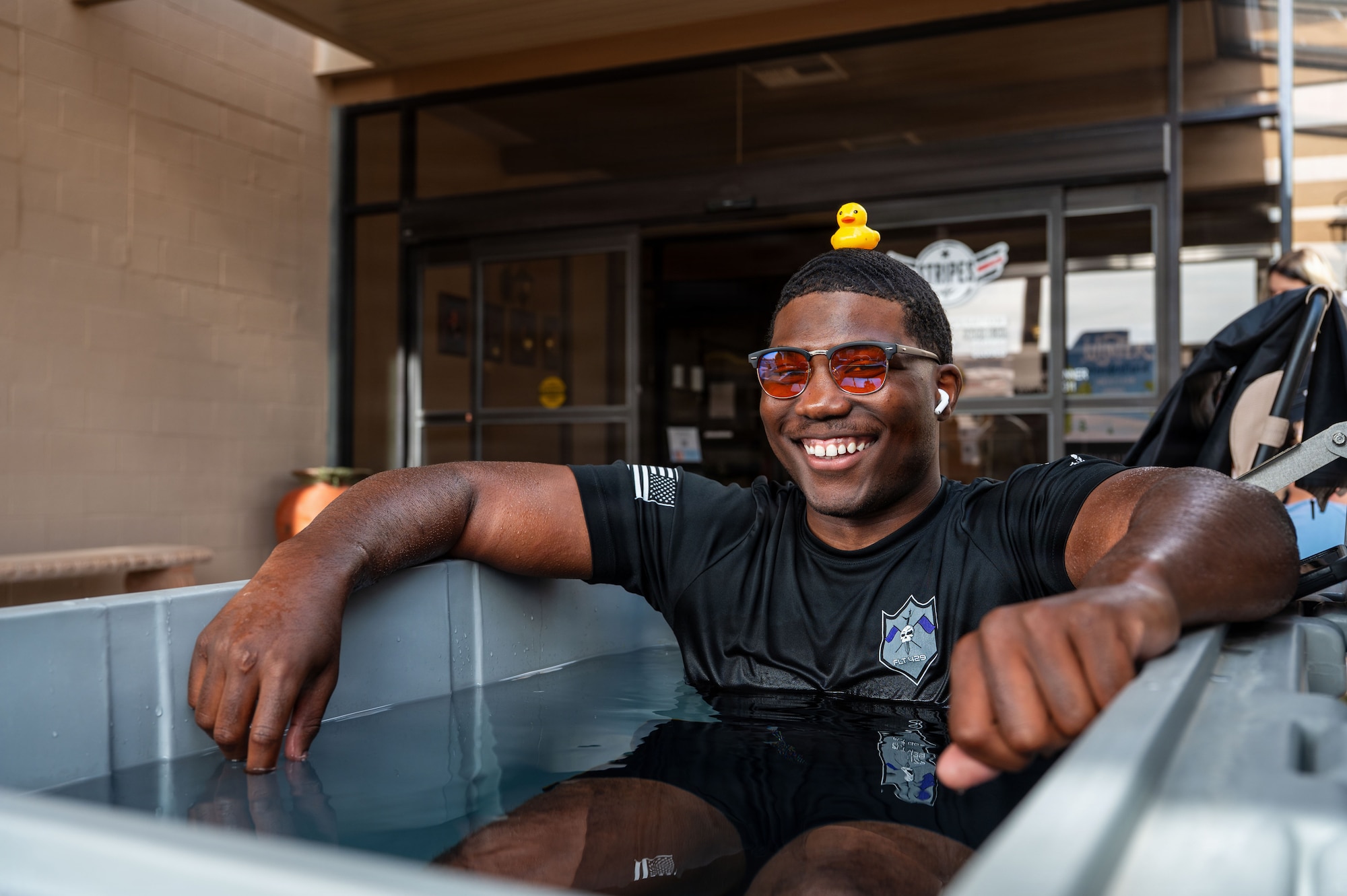 A U.S. Airman uses an ice bath during the “Connect 4 Wellness” fair at Davis-Monthan Air Force Base, Arizona, Dec. 23, 2025. The fair offered various wellness activities to help the Desert Lightning Team unwind over the holiday season. (U.S. Air Force photo by Senior Airman Jasmyne Bridgers-Matos)