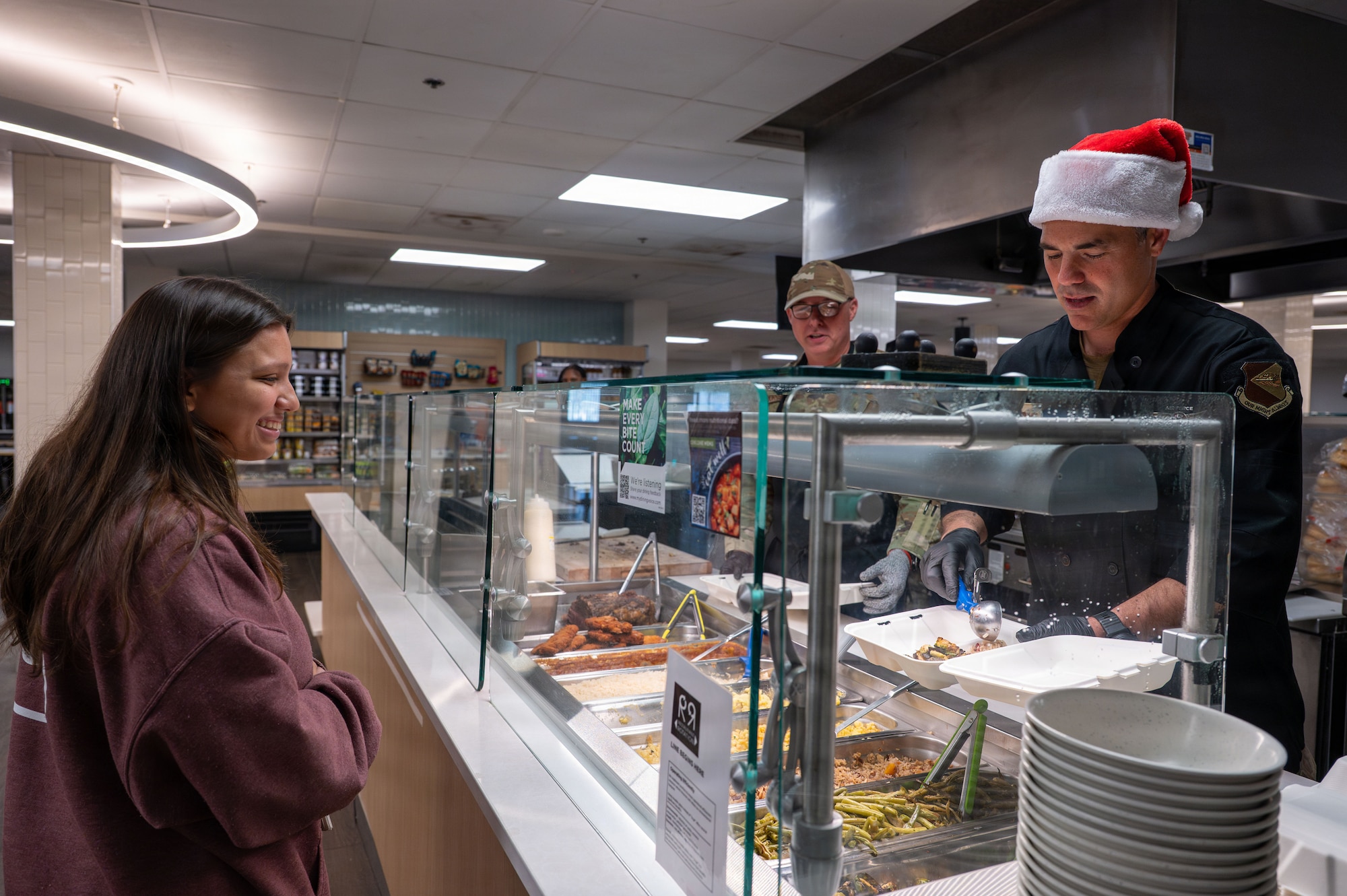 U.S. Air Force Col. Jose Cabrera, 355th Wing commander, serves Airmen a holiday meal at 
Davis-Monthan Air Force Base, Arizona, Dec. 25, 2025. The dining facility team and base leadership coordinated to serve Airmen a meal on Christmas. (U.S. Air Force photo by Senior Airman Jasmyne Bridgers-Matos)