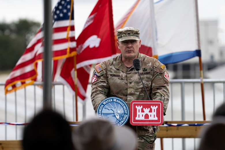 Jacksonville District Commander giving a speech behind the podium in front of one of the Biscayne Bay's Pumpstation