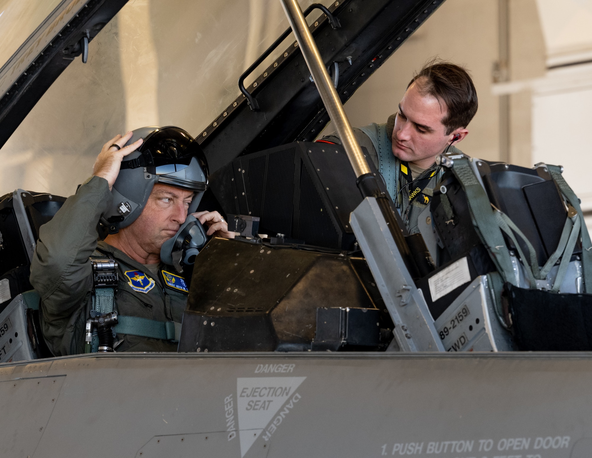 U.S. Air Force Chief Master Sgt. Keith Scott, 19th Air Force command chief, left, and Capt. Samuel Galbreath, pilot, prepare for an F-16 Fighting Falcon training sortie on Holloman Air Force Base, New Mexico, Dec. 16, 2025.