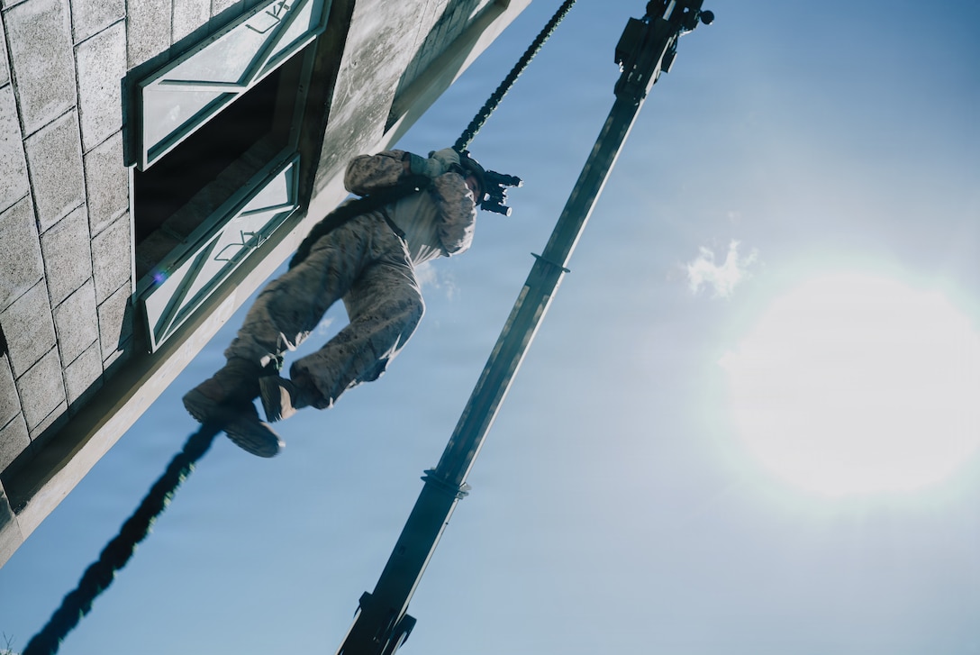 A U.S. Marine Corps rifleman with Lima Company, Battalion Landing Team 3/6, 22nd Marine Expeditionary Unit (Special Operations Capable), conducts fast-rope training at Camp Santiago, Puerto Rico, Dec. 18, 2025. U.S. military forces are deployed to the Caribbean in support of the U.S. Southern Command mission, Department of War-directed operations, and the president's priorities to disrupt illicit drug trafficking and protect the homeland. (U.S. Marine Corps photo)