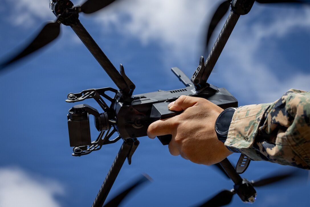 A U.S. Marine with Combat Logistics Battalion 26, 22nd Marine Expeditionary Unit (Special Operations Capable) prepares to launch a Skydio X2D small unmanned aircraft system during a seeking exercise at Camp Santiago, Puerto Rico, Dec. 19, 2025. U.S. military forces are deployed to the Caribbean in support of the U.S. Southern Command mission, Department of War-directed operations, and the president's priorities to disrupt illicit drug trafficking and protect the homeland. (U.S. Marine Corps photo)