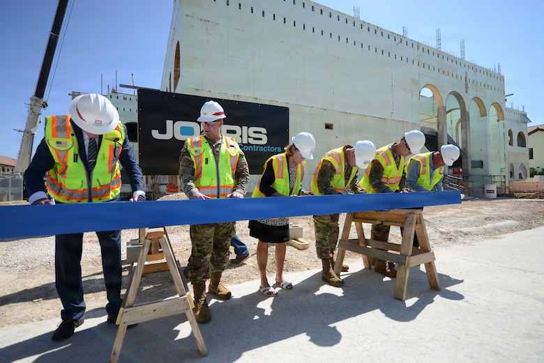 Senior leaders from the U.S. Air Force, the U.S. Army Corps of Engineers and the project’s construction contractor sign a ceremonial steel beam during the topping off event for the B Wing 495 addition at JBSA Randolph, Texas. The beam signing marked placement of the final structural steel, a long-standing construction tradition that celebrates reaching full building height and recognizes the teamwork behind the net zero facility’s progress. Once finished, the facility will provide expanded workspace for the Air Force’s Personnel Center teams supporting 24/7 operations for mass casualty tracking, disability processing and other mission critical operations. 



The $29.7 million project, managed by the U.S. Army Corps of Engineers Fort Worth District, consolidates critical AFPC missions while incorporating energy saving features such as insulated concrete forms, a high efficiency HVAC system, and rooftop solar panels, creating a net zero facility. (U.S. Air Force photo by Robert Lyon)