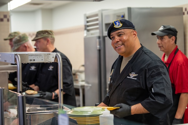 Senior enlisted airman, prepares a meal for a customer