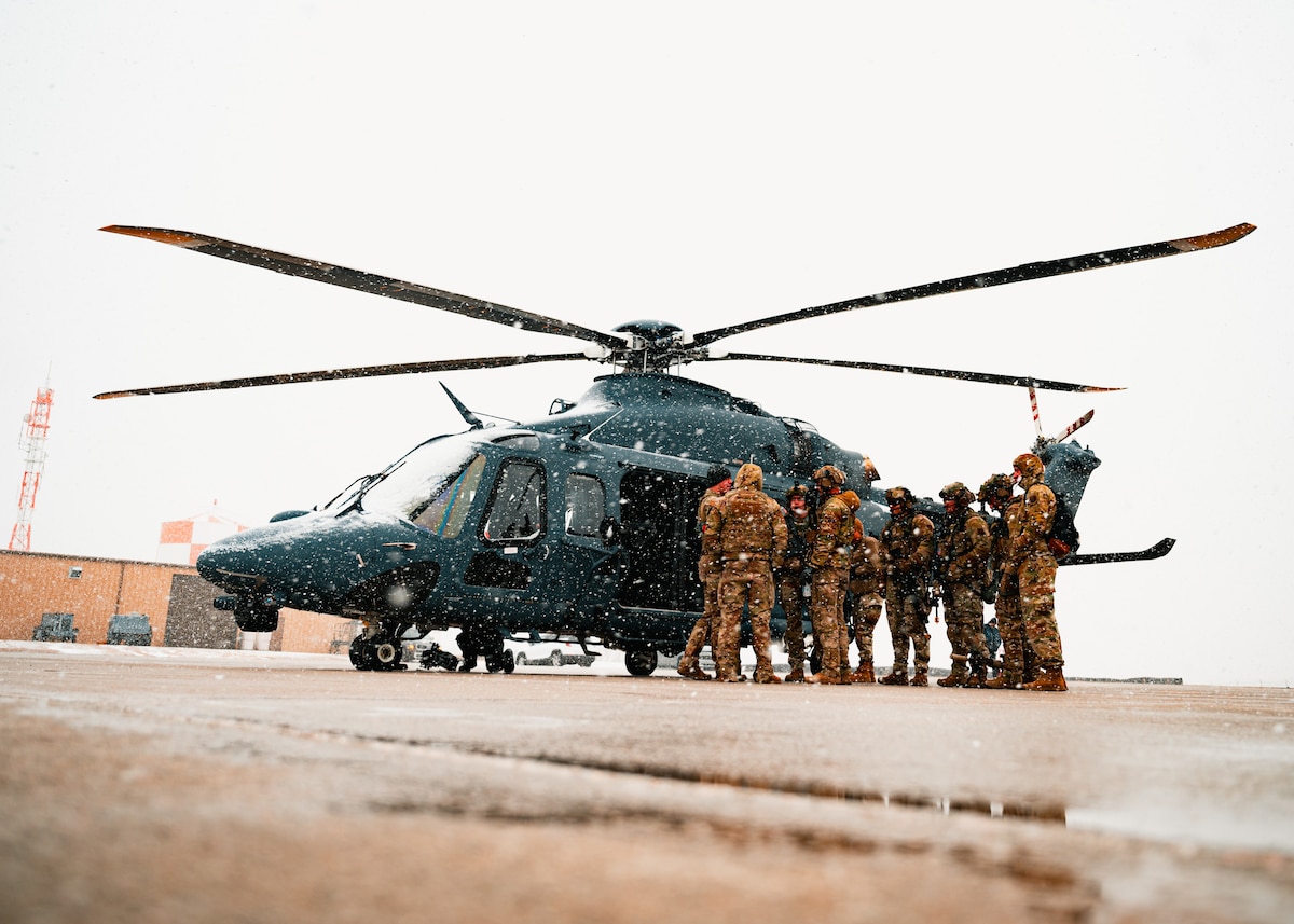 90th Missile Security Forces Squadron Tactical Response Force defenders prepare to board a 550th Helicopter Squadron MH-139 Grey Wolf during a nuclear convoy course at Camp Guernsey Joint Training Center, Wyo., April 4, 2025. The 550 HS provided aerial support to enhance ground security operations and refine joint air-to-ground coordination alongside 20th Air Force convoy response force defenders. (U.S. Air Force photo by Staff Sgt. Michael A. Richmond)