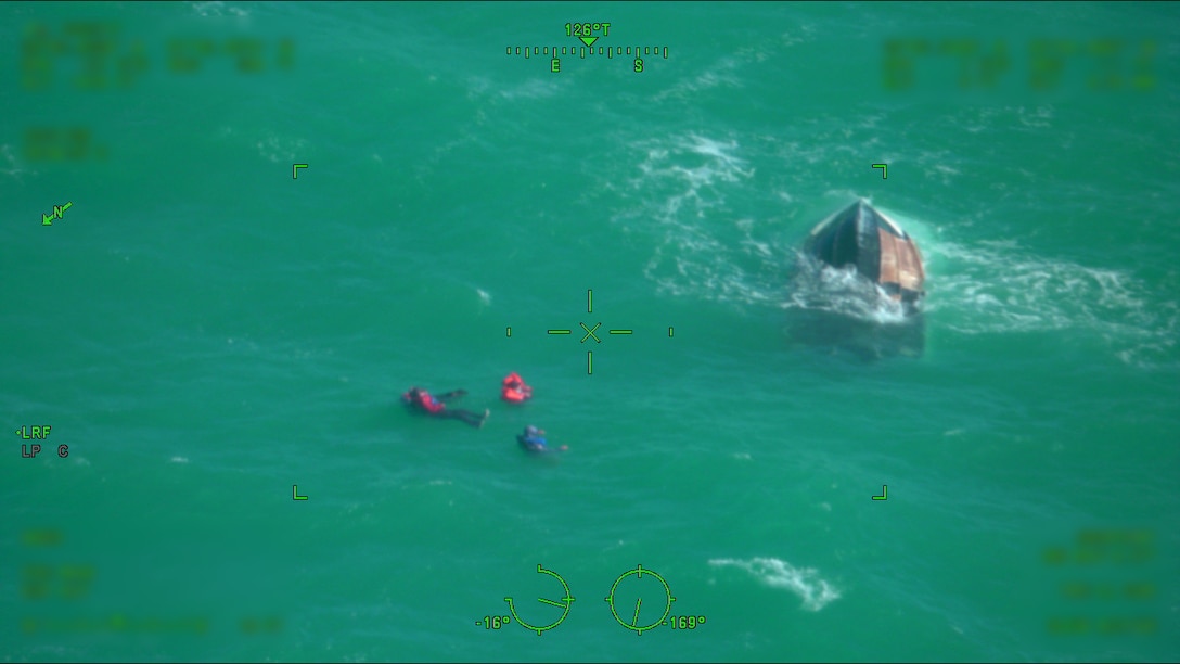 A U.S. Coast Guard rescue swimmer assists in the rescue of four survivors of a capsized vessel approximately 30 miles north of Key West, Florida, Dec. 31, 2025. An MH-60S Marlin helicopter crew from Naval Air Station Key West provided assistance with the rescue. (U.S. Coast Guard photo)